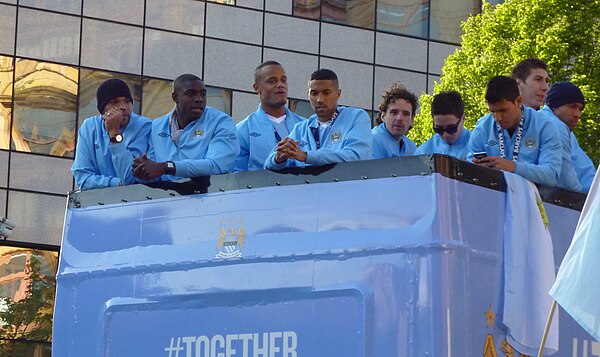 Richards (second left) on an open-top bus victory parade after Manchester City won the Premier League, 2012.