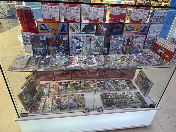 Display case at Toy Kingdom, showing off Nintendo Switch games and handhelds with accessories