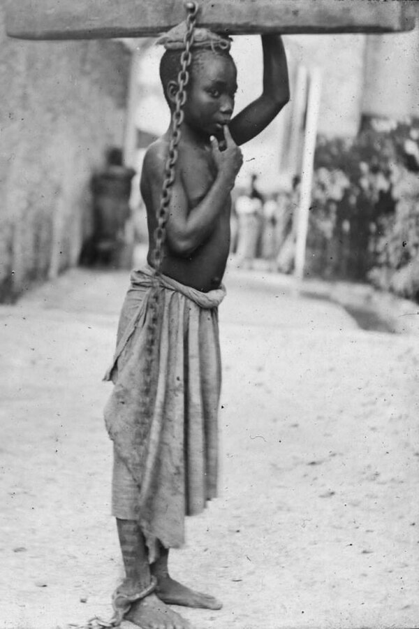 Zanzibar child slave sentenced to transport logs by Arab master in Sultanate, 1890s